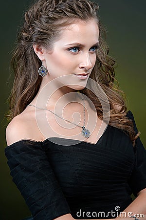 Beauty and Jewelry woman in black dress modern style with hairstyle and silver jewelry. Fashion brunet model with necklace Stock Photo