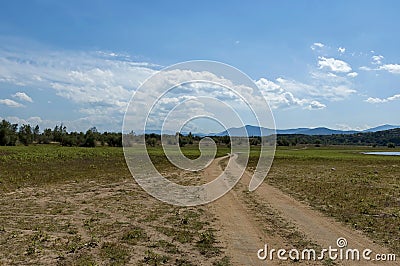 Beauty look toward picturesque field with cracked dry way near by Rabisha lake Stock Photo