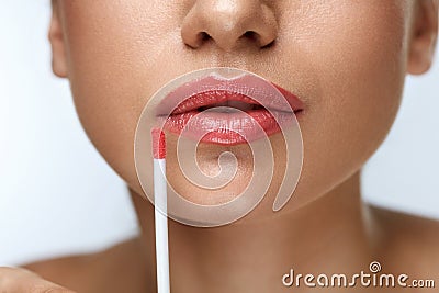 Beauty Makeup. Beautiful Woman Applies Lip Gloss Stock Photo