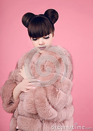 Beauty makeup. Fashion teen girl model in fur coat. Brunette wit Stock Photo