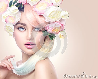 Beauty model girl with colorful flowers wreath and colorful hair. Flowers hairstyle Stock Photo