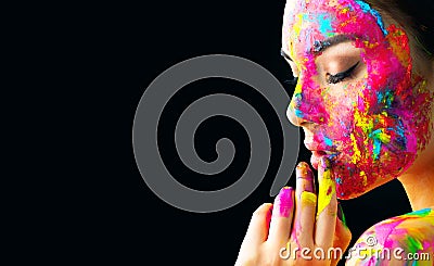 Beauty model girl with colorful paint on her face. Portrait of beautiful woman with flowing liquid paint Stock Photo