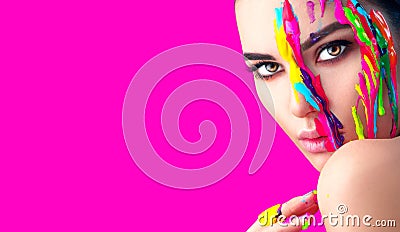 Beauty model girl with colorful paint on her face. Portrait of beautiful woman with flowing liquid paint Stock Photo