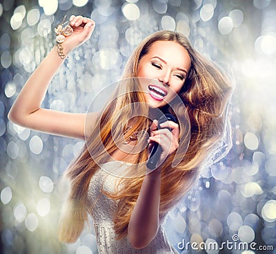 Beauty model girl with a microphone Stock Photo