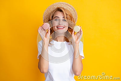 Beauty model girl taking colorful macaroons. Beautiful woman eating sweets macaron. Stock Photo