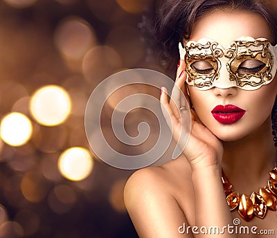 Beauty model woman wearing venetian masquerade carnival mask at party Stock Photo