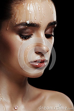 Beauty Portrait of Young Woman with Strobing Makeup Liquid on Fa Stock Photo