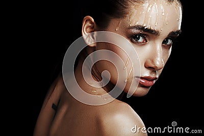 Beauty Portrait of Young Woman with Strobing Makeup Liquid on Fa Stock Photo