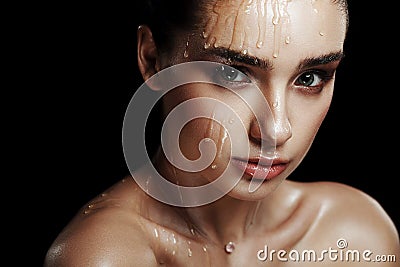 Beauty Portrait of Young Woman with Strobing Makeup Liquid on Fa Stock Photo