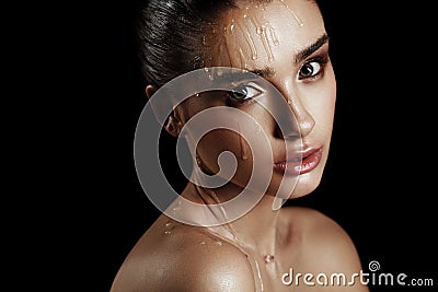 Beauty Portrait of Young Woman with Strobing Makeup Liquid on Fa Stock Photo