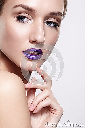 Beauty portrait of young woman with violet lips makeup Stock Photo