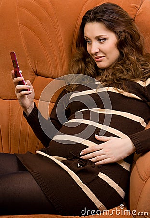 Beauty pregnant women reading sms Stock Photo