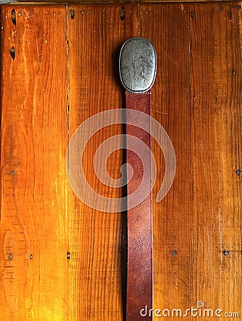 Western Belt and Silver Buckle on Wooden Chest Stock Photo