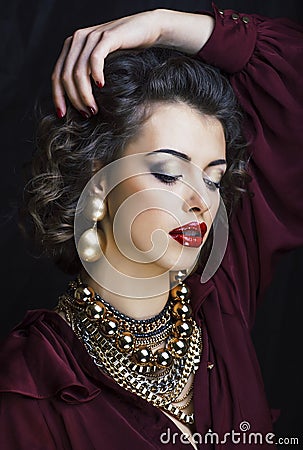 beauty rich brunette woman with a lot of gold jewellery, hispani Stock Photo