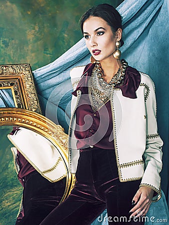 Beauty rich brunette woman in luxury interior near empty frames, vintage elegance brunette Stock Photo