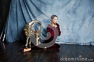 Beauty rich brunette woman in luxury interior near empty frames, vintage elegance brunette stylish Stock Photo