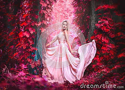 Beauty romantic young woman in long chiffon dress with gown posing in fantasy misty forest. Beautiful happy bride model girl Stock Photo