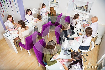 Beauty salon. Women doing manicure. Manicure specialists in the workplace Stock Photo