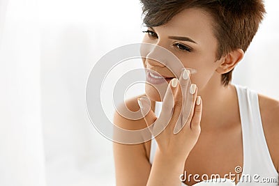 Beauty Skin Care. Beautiful Woman Applying Cosmetic Face Cream Stock Photo
