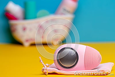 Beauty and skincare concept. Selective focus on a modern pink electric rechargeable face cleansing silicone brush and massage Stock Photo