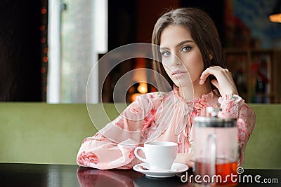 Beauty smiling happy model with natural make up and long eyelashes smiles in cafe Stock Photo