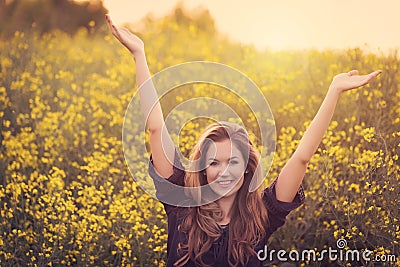 Beauty smiling woman in yellow rapeseed field Stock Photo