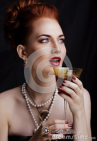 Beauty stylish redhead woman with hairstyle and manicure wearing jewelry pearl close up Stock Photo