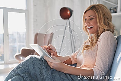 Beauty surfing the net. Attractive young woman using digital tab Stock Photo