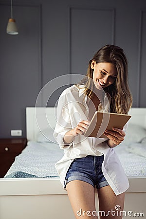 Attractive young woman using digital tablet and relaxing Stock Photo