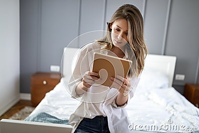 Attractive young woman using digital tablet and relaxing Stock Photo