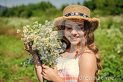 Beauty is taking time to get pampered. Happy girl smile with chamomile bunch. Beauty look of small kid. Natural skincare Stock Photo