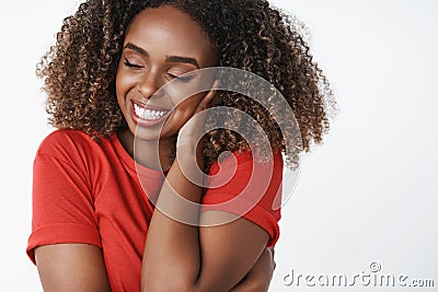 Beauty, tenderness and sensuality concept. Indoor shot of carefree relaxed and happy young healthy african-american girl Stock Photo