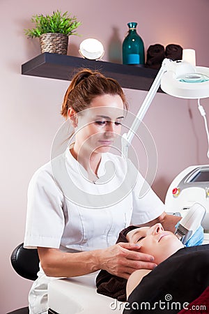 Beauty treatment in modern beauty salon. Beautician Stock Photo