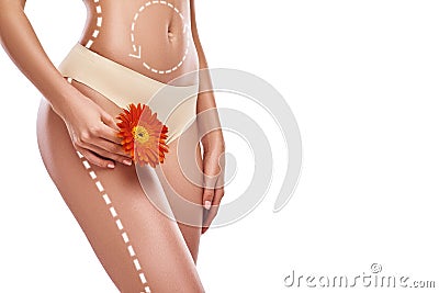 Beauty of woman body. Cropped photo of slim woman showing her thigh with red flower on it while standing against white Stock Photo