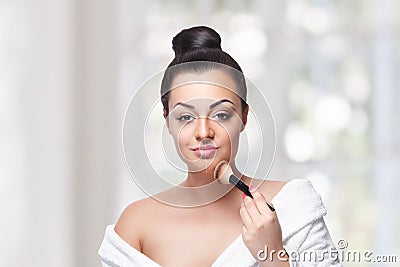 Beauty woman contouring with a makeup brush Stock Photo