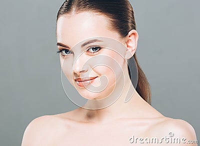 Beauty Woman face Portrait. Beautiful Spa model Girl with Perfect Fresh Clean Skin. Gray background Stock Photo