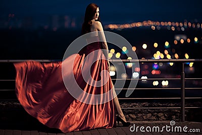 Beauty Woman In Fluttering Red Dress Outdoor Stock Photo