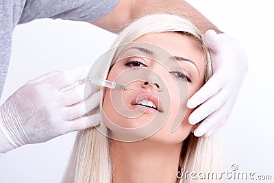 Beauty woman giving botox injections Stock Photo