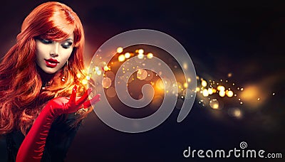 Beauty woman with golden magic sparks in her hand Stock Photo