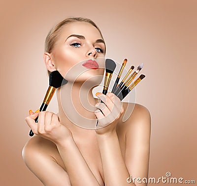 Beauty woman with makeup brushes Stock Photo