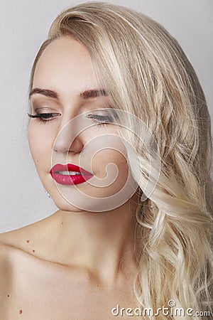 Beauty Woman with Perfect Makeup. Beautiful Professional Holiday Make-up. Red Lips and Nails. Beauty Girl`s Face isolated on Black Stock Photo