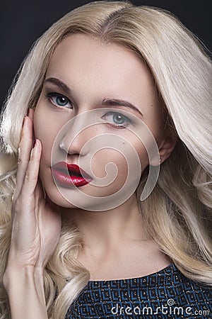 Beauty Woman with Perfect Makeup. Beautiful Professional Holiday Make-up. Red Lips and Nails. Beauty Girl`s Face isolated on Black Stock Photo