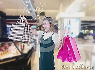 Beauty Woman with Shopping Bags in Shopping Mall. Shopper. Sales Stock Photo