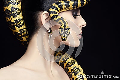 Beauty woman, snake, jewelry and make-up Stock Photo