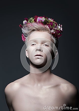 Beauty. Young Man with Wreath of Flowers over Gray Stock Photo