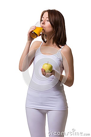 Beauty young woman drinks apple juice from glass a Stock Photo