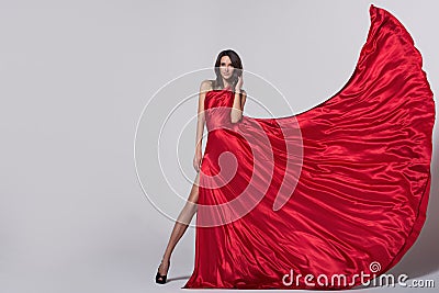 Beauty young woman in fluttering red dress Stock Photo