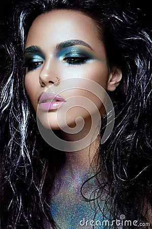 Beautyful girl with blue glitter on her face Stock Photo