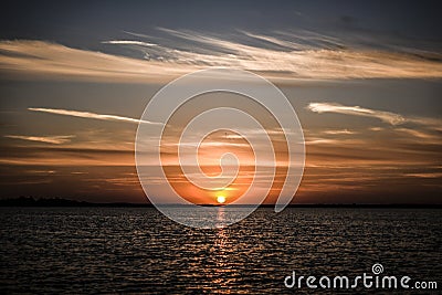 Beautyful sunset with clouds on the sky by the bea Poland. Stock Photo