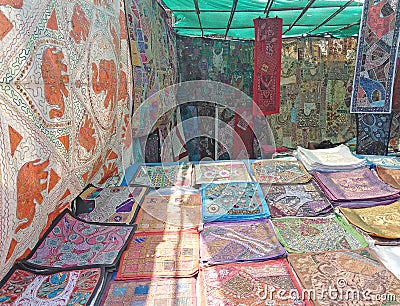 Bed covers for sale on Wednesday Flea Market in Anjuna, Goa, India. Editorial Stock Photo